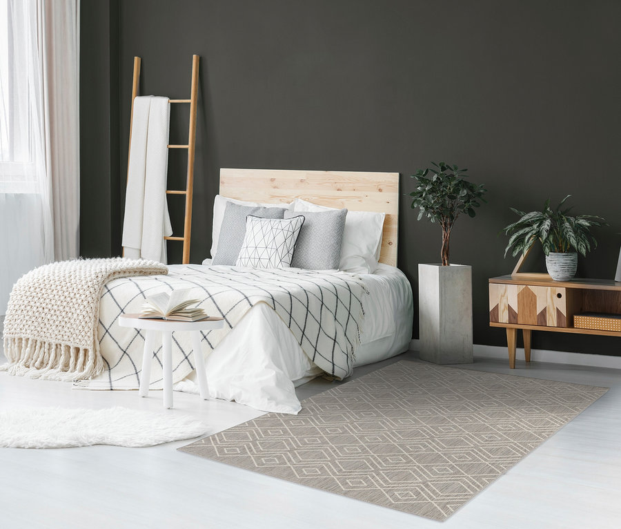 Schlafzimmer mit Bett, Holzleiter, Topfpflanze und braunem, faltbarem Outdoor-Teppich »Diamond Rhythm«.