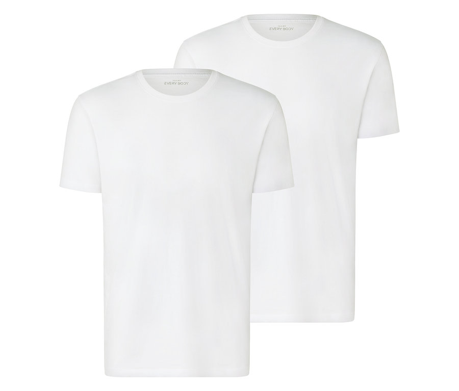 Zwei weiße T-Shirts liegen übereinander.