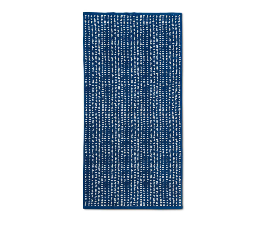 Ein blaues Jacquard-Badetuch mit weißen Tupfen.