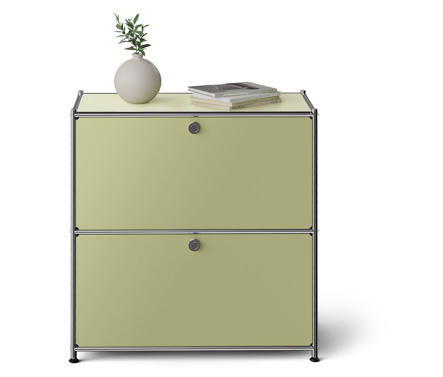 Grüner Schrank mit zwei Schubladen. Vase und Buch auf der Oberseite.
