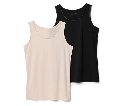 Zwei Tanktops, eines beige und eines schwarz, liegen flach. Das beige ist im Vordergrund, das schwarze leicht dahinter.