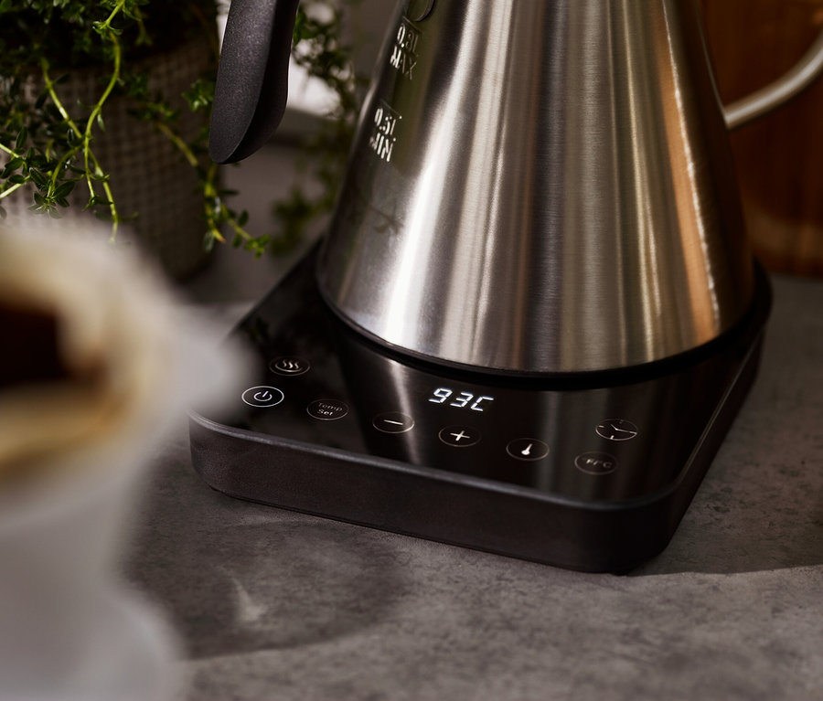 Detailansicht eines elektrischen Schwanenhalskessels aus Edelstahl auf einer schwarzen Basis mit digitaler Anzeige.