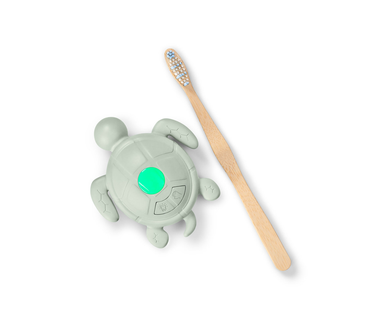 Ein Händewasch-und-Zahnputz-Timer in Schildkrötenform mit grünem Licht und eine Holzzahnbürste.