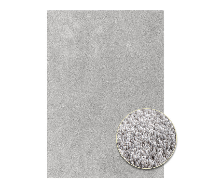 Nahaufnahme eines hellgrauen Teppichs "Mellow" mit Detailansicht der Textur.