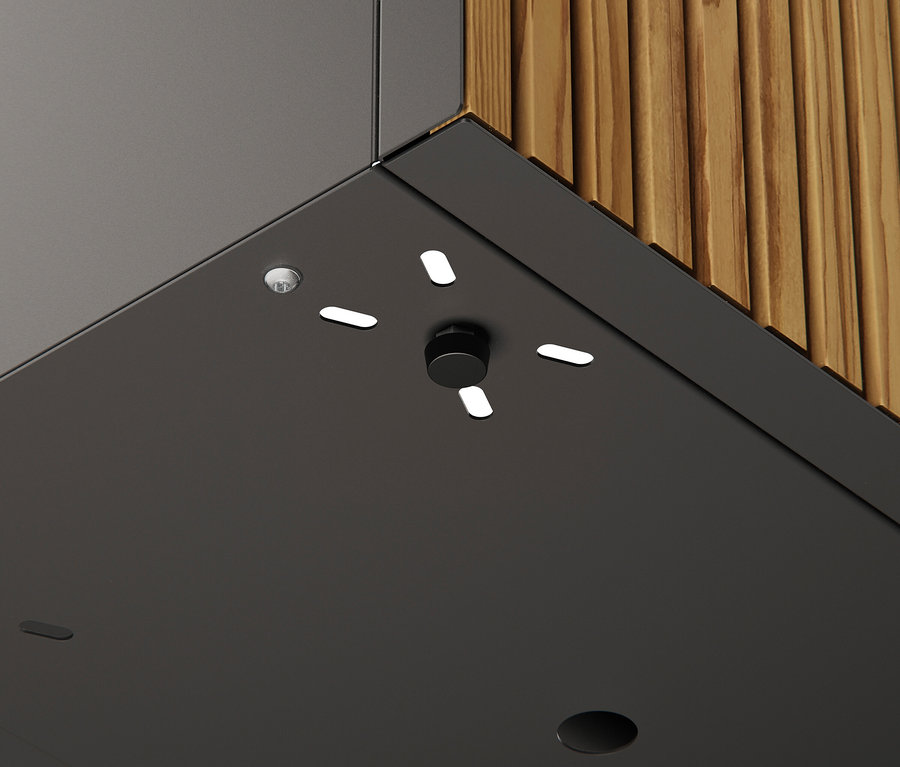 Nahaufnahme einer grauen Oberfläche mit einem schwarzen Drehknopf und LED-Leuchten, angrenzend an eine Wand mit Holzpaneelen.