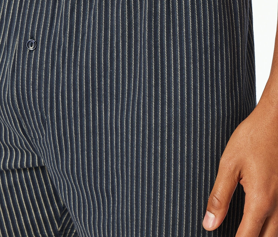 Detailaufnahme von Herren-Boxershorts mit Streifenmuster, Knopf und Schiesser-Logo.