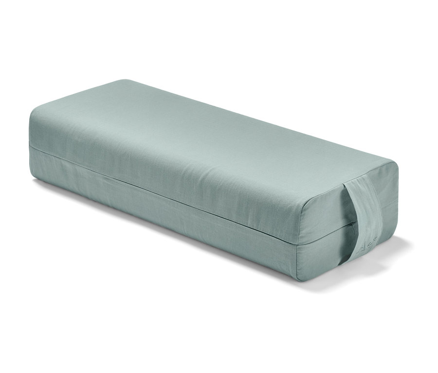 Ein hellgrüner Yoga-Bolster.