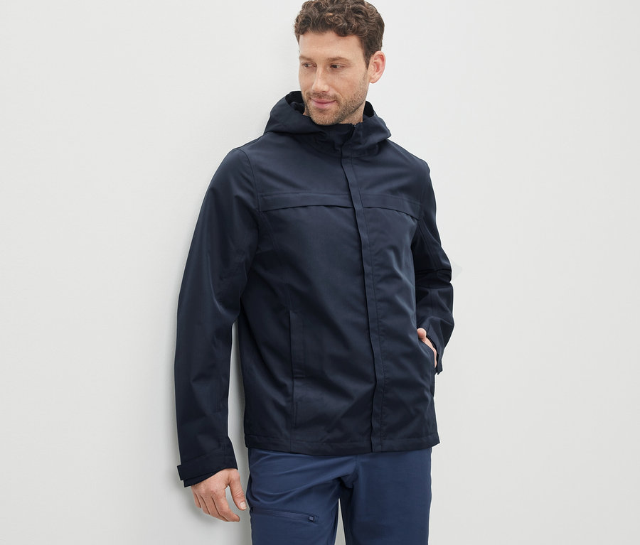 Mann trägt einen dunkelblauen Funktionsparka.