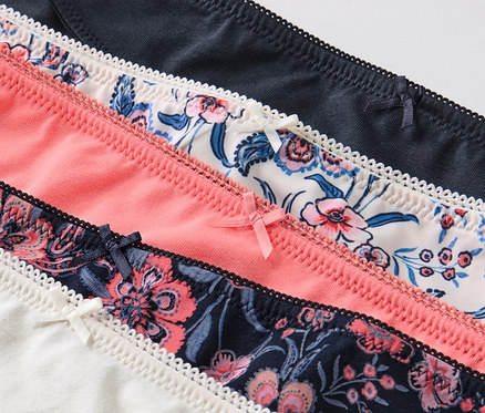 Detailansicht von fünf Slips mit Blumenmustern und Spitzen.
