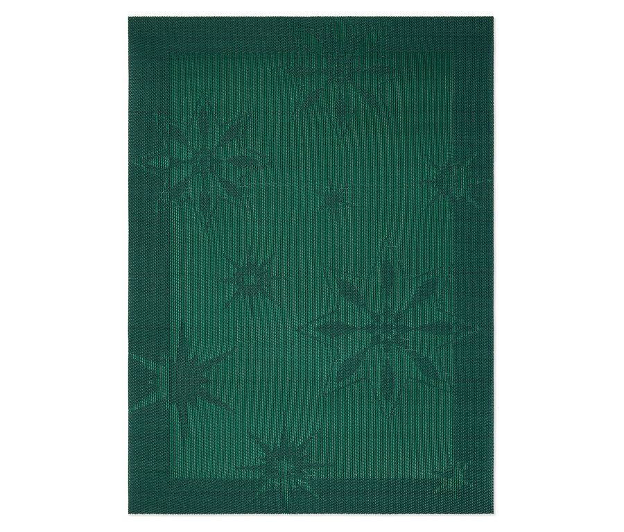 Detailaufnahme eines grünen Stofftischsets mit Sternmuster.