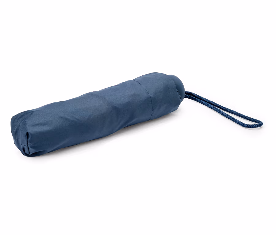 Ein dunkelblau verpackter Regenschirm liegt auf einem weißen Hintergrund. Eine blaue Kordel hängt daran.