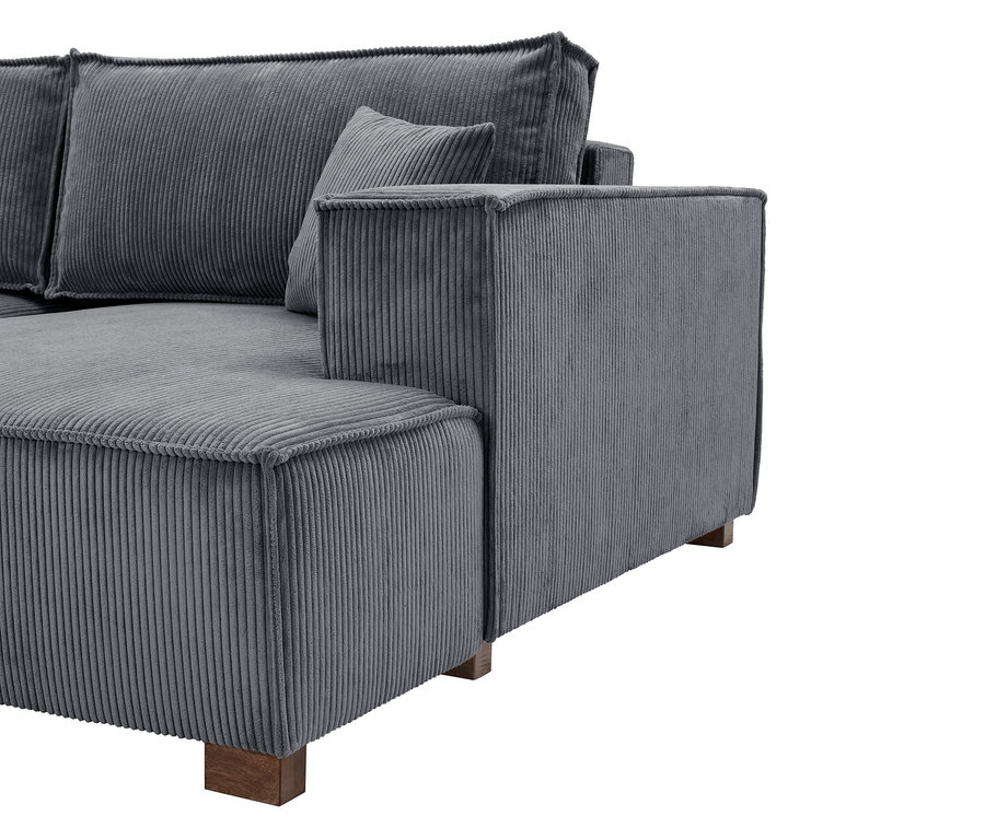 Nahaufnahme eines grauen Cord Sofas mit Kissen.