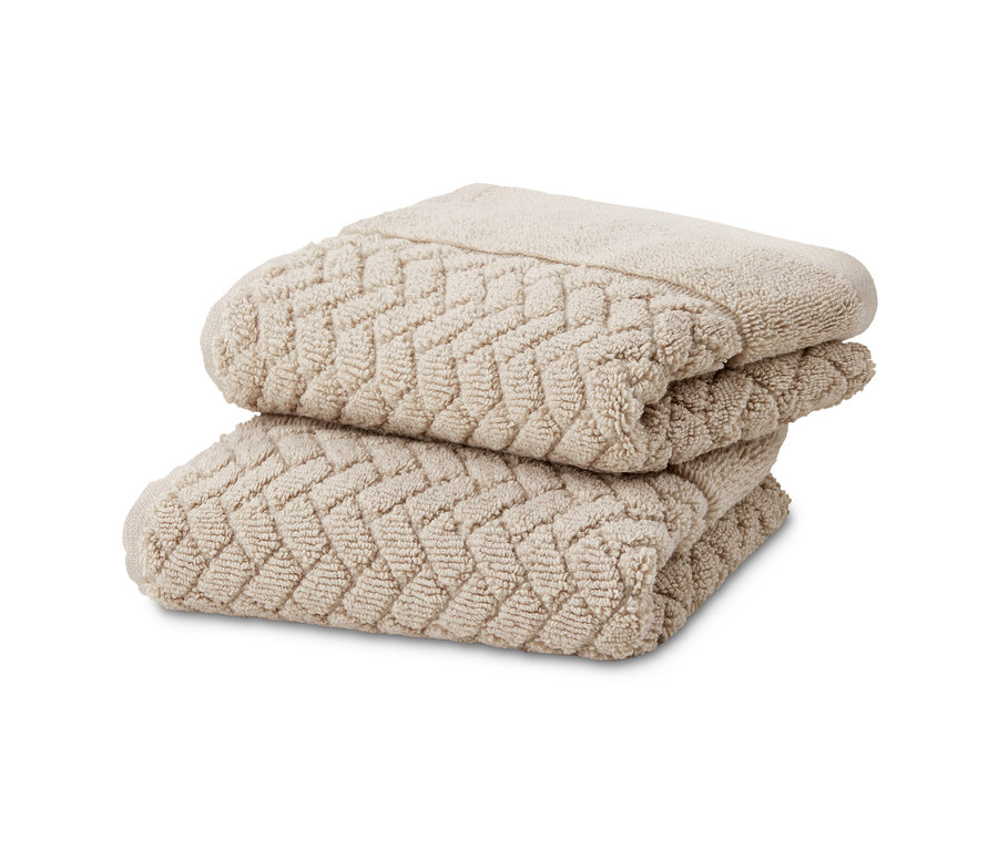 Zwei beige Vestio-Jacquard-Gästehandtücher, 2er-Set, sind gestapelt.