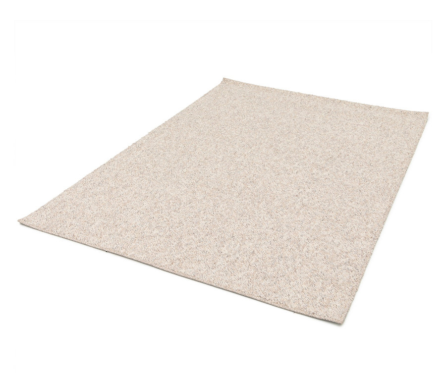 Ein beiger Teppich liegt auf einem weißen Hintergrund.