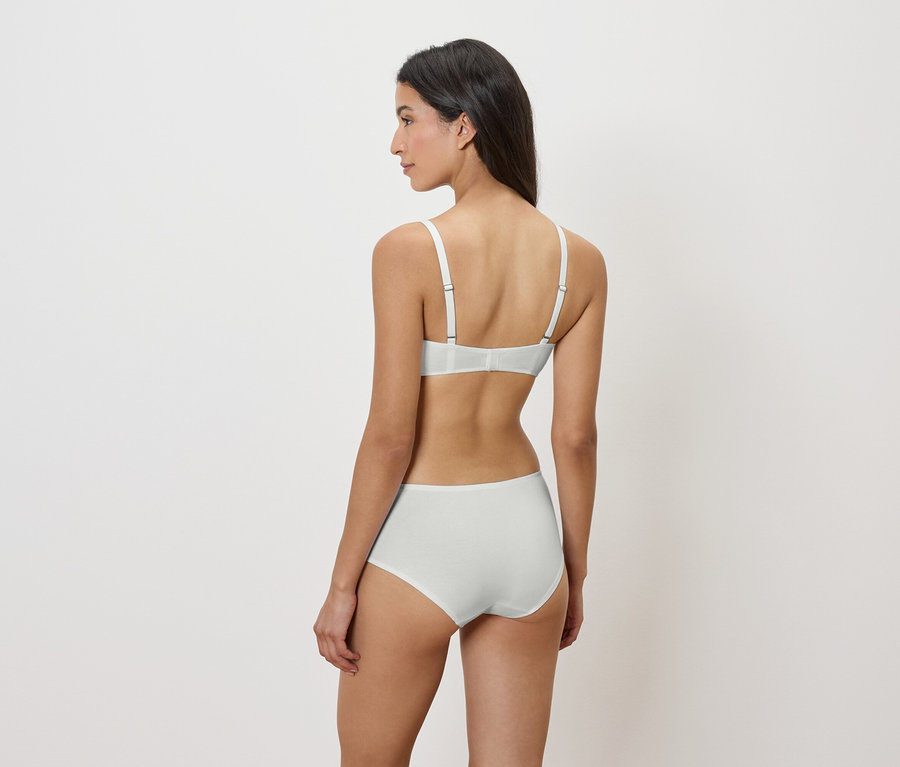 Frau von hinten, trägt einen weißen BH und Höschen.