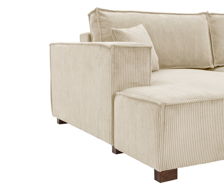 Nahaufnahme eines cremefarbenen Cordsofas mit Armlehne und Rückenkissen.