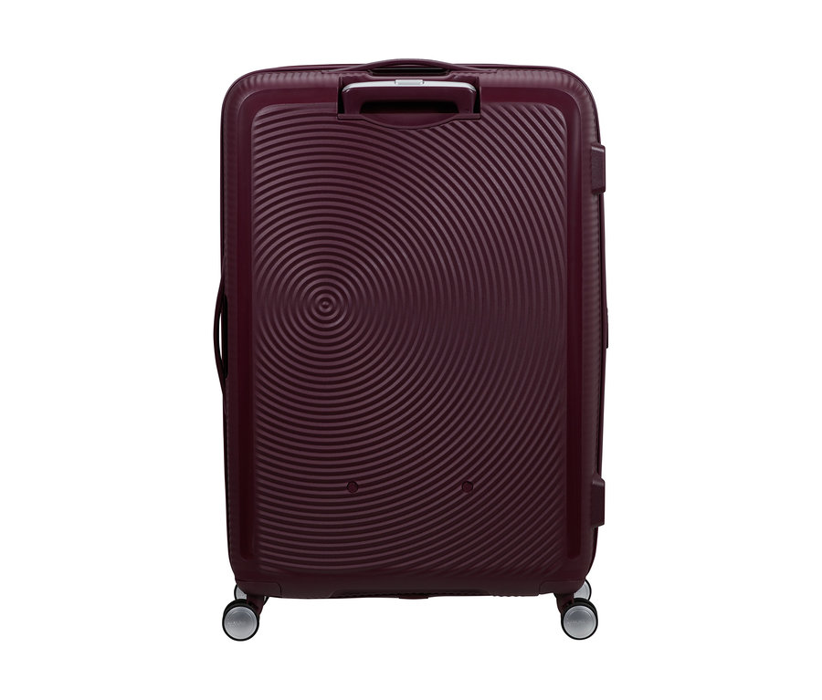 Großer American Tourister Soundbox Spinner Hartschalen-Koffer in Wildkirschrot mit konzentrischen Kreismustern und vier Rollen.