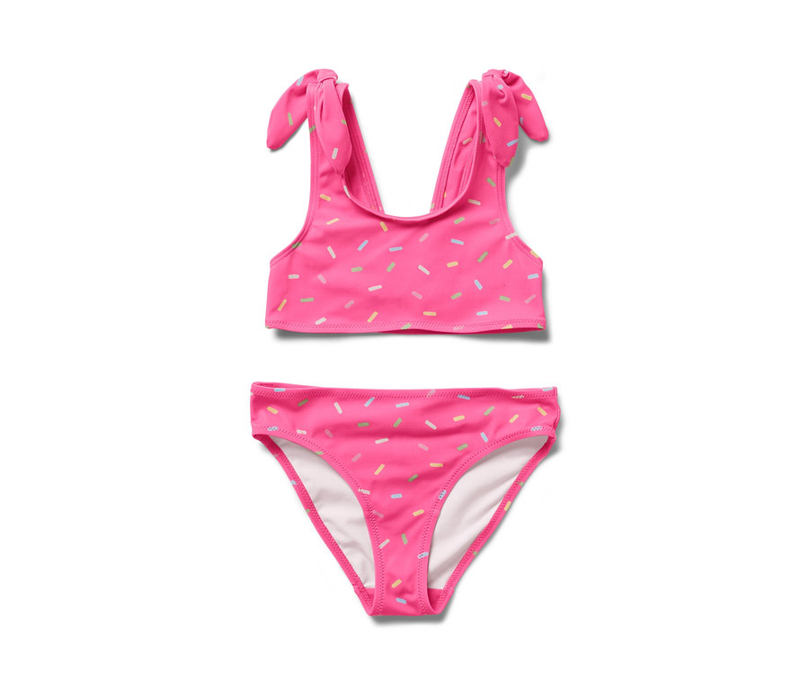 Ein zweiteiliger Kinder-Bikini in Pink mit bunten Streuseln.