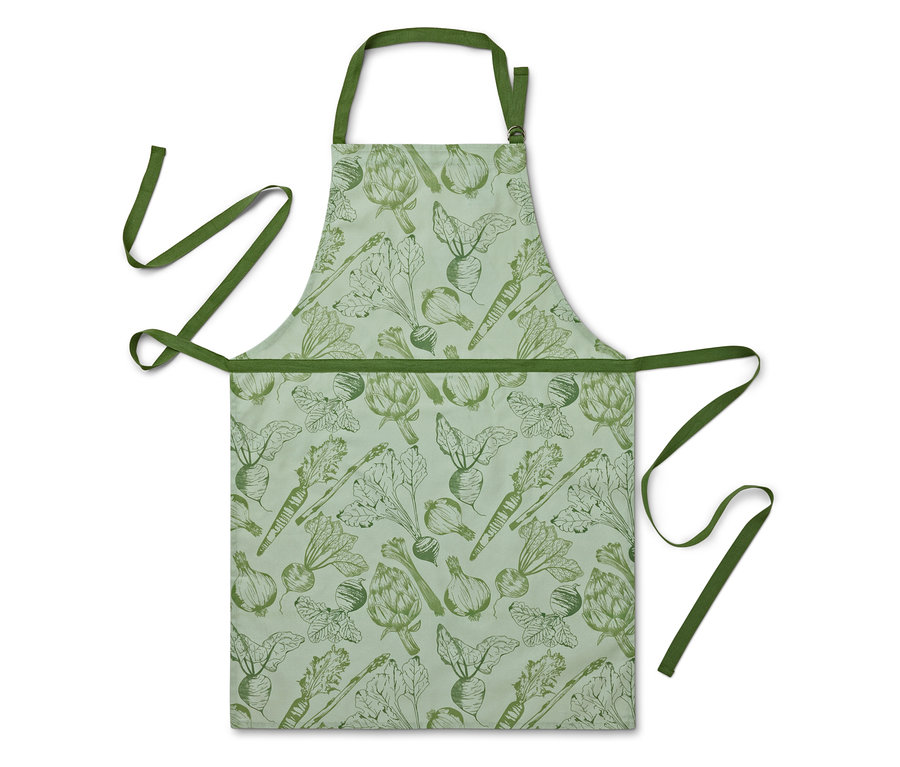 Eine Schürze mit Gemüseaufdruck auf hellgrünem Hintergrund.