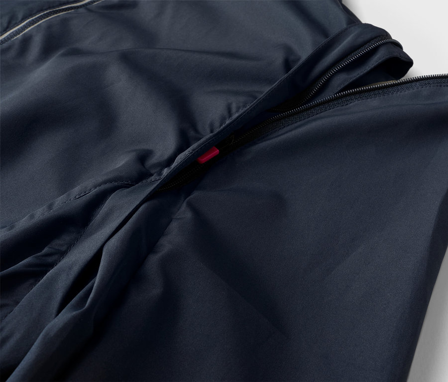 Nahaufnahme einer marineblauen Jacke mit teilweise geöffnetem Reißverschluss.
