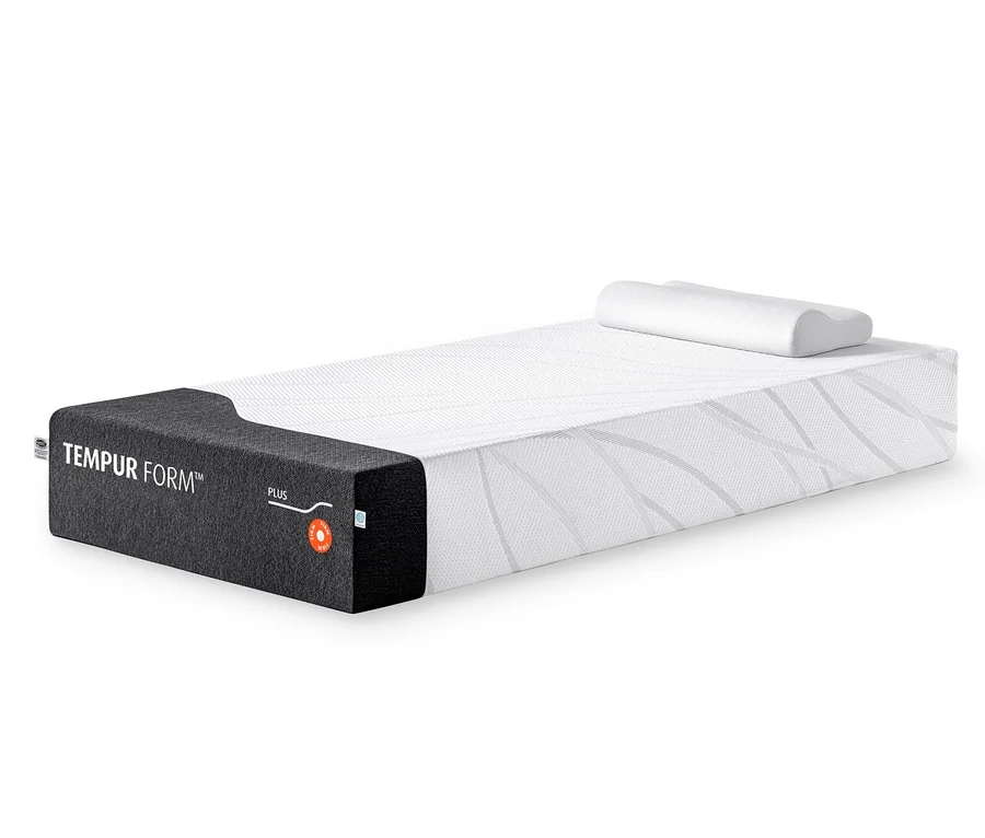 TEMPUR FORM™ Plus Matratze, firm, mit weißem Bezug und dunkler Seitenwand, darauf ein konturiertes Kissen.