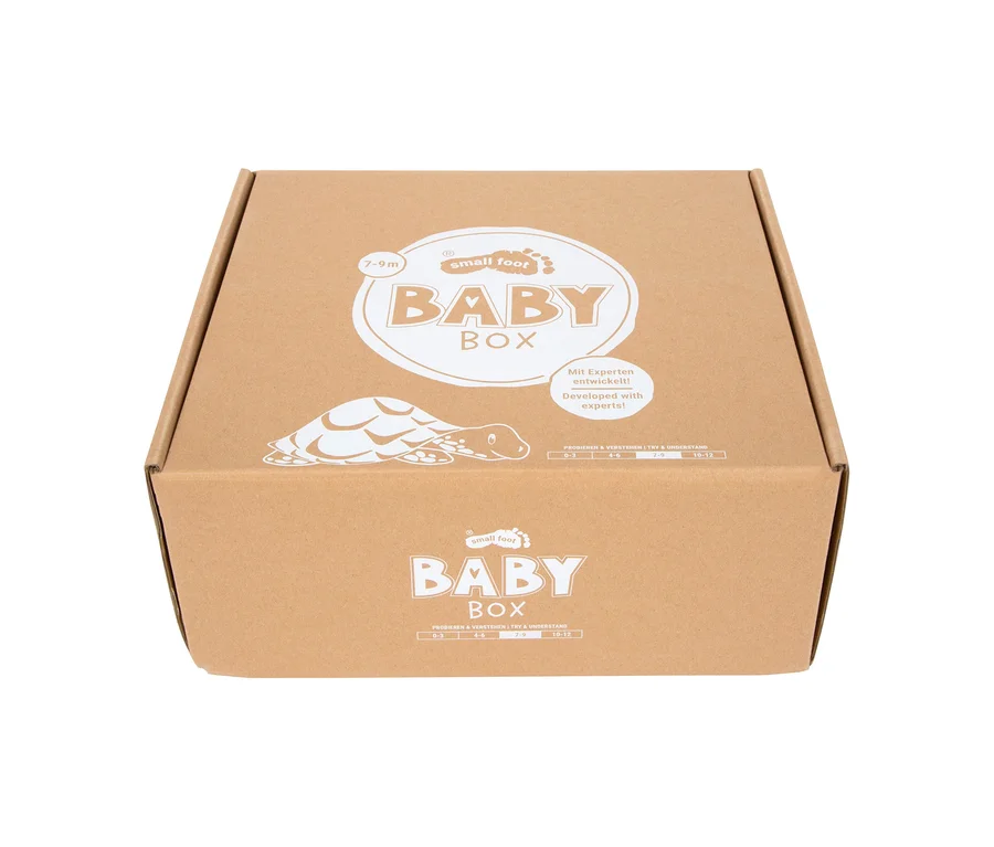 Brauner Karton der small foot Baby-Box, 7–9 Monate, mit Schildkrötenmotiv und Aufschrift "Developed with experts!".
