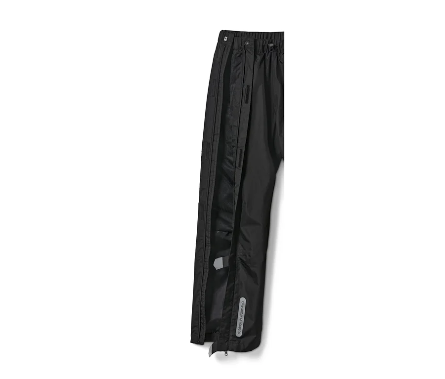 Detailansicht einer schwarzen High-Tech-Regenhose, deren seitlicher Reißverschluss geöffnet ist.