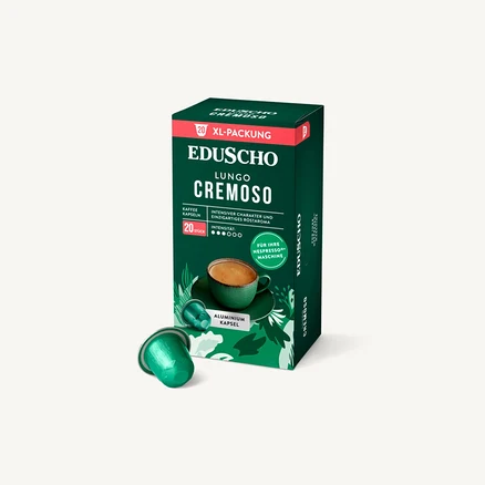 Eine Packung Eduscho Lungo Cremoso Kaffeekapseln steht neben zwei einzelnen Aluminiumkapseln.