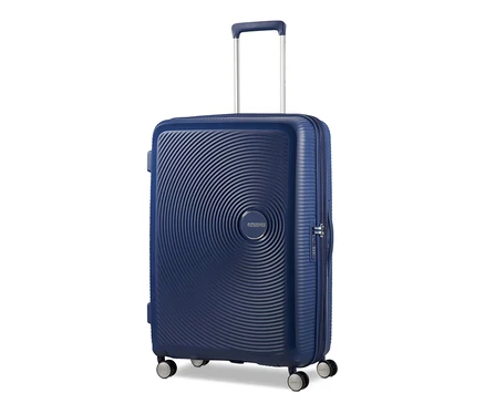 Nahaufnahme eines großen, marineblauen American Tourister Hartschalenkoffers »Soundbox« Spinner.