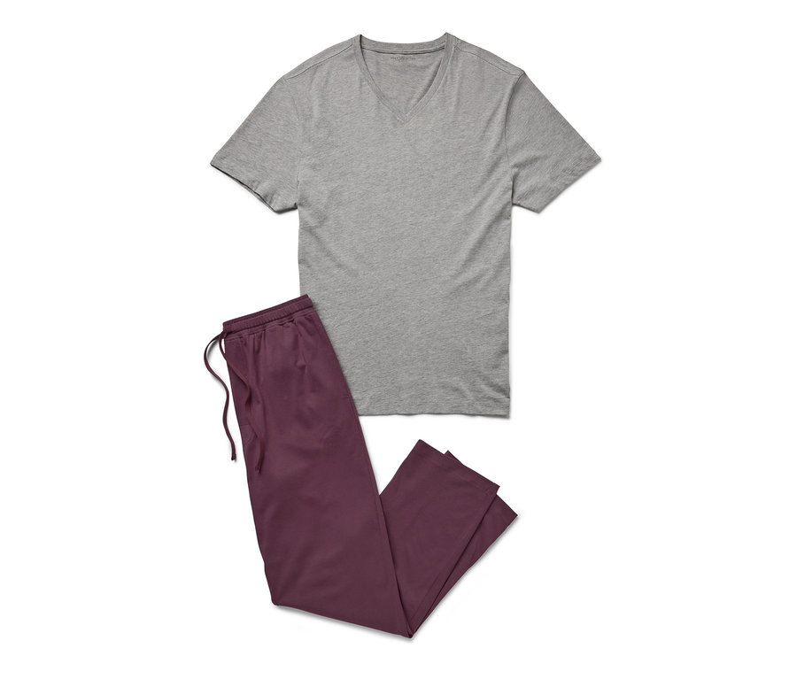Grauer Pyjama mit burgunderroter Hose liegt auf einem weißen Hintergrund.