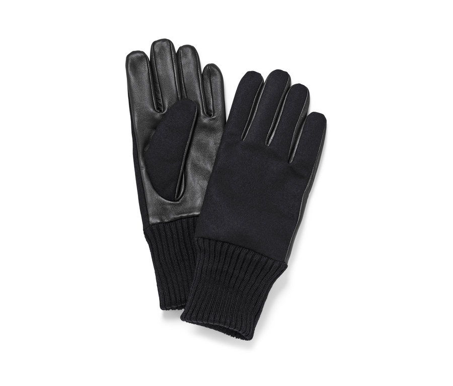 Zwei schwarze Lederhandschuhe liegen nebeneinander.
