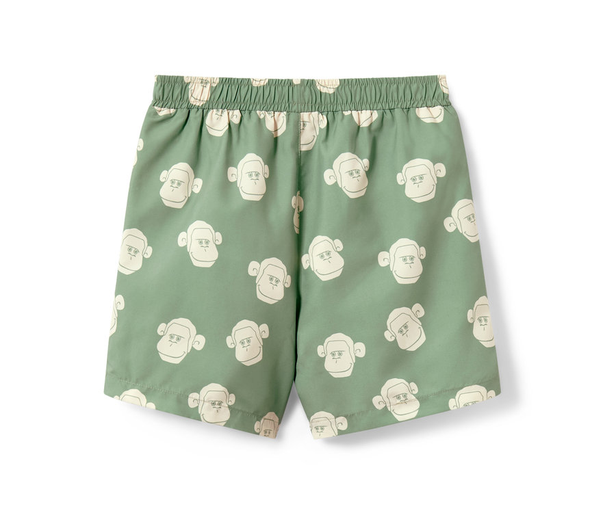 Grüne Kinder-Boardshorts mit Affenmuster.
