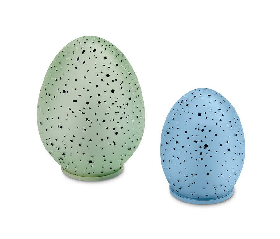 Zwei LED-Dekoeier, eines grün und eines blau, mit schwarzen Flecken.