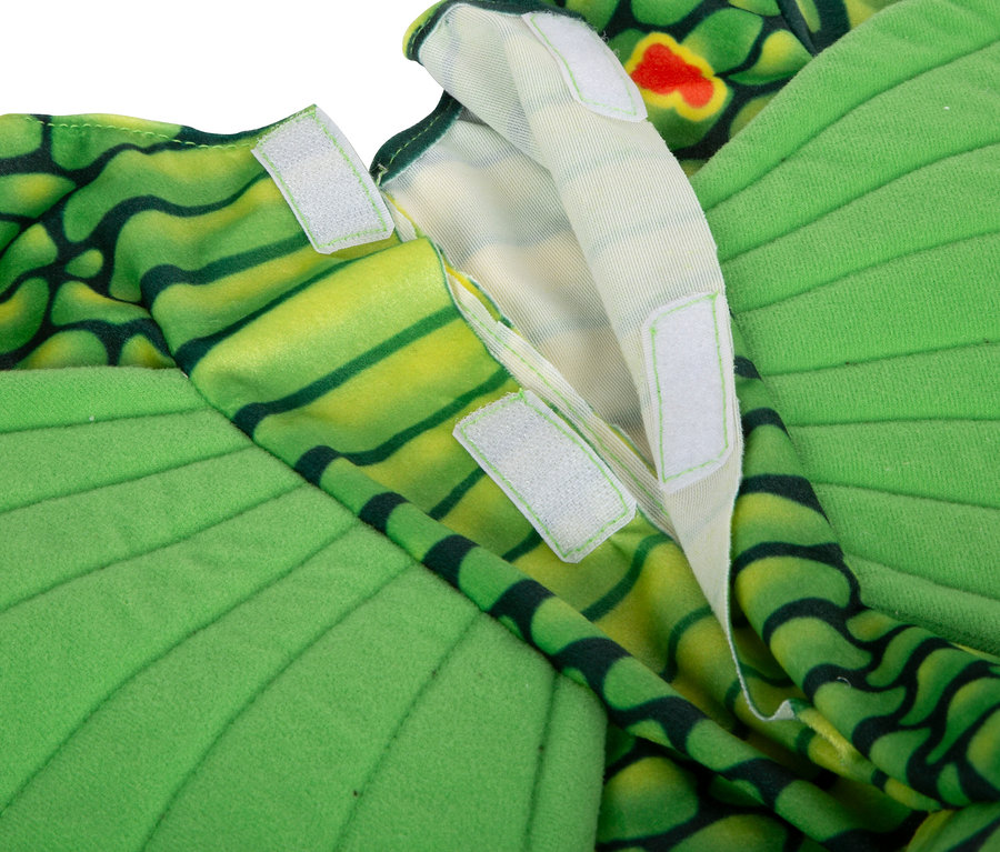 Detailansicht des grünen small foot Kostüms »Drache« mit Klettverschlussdetails.