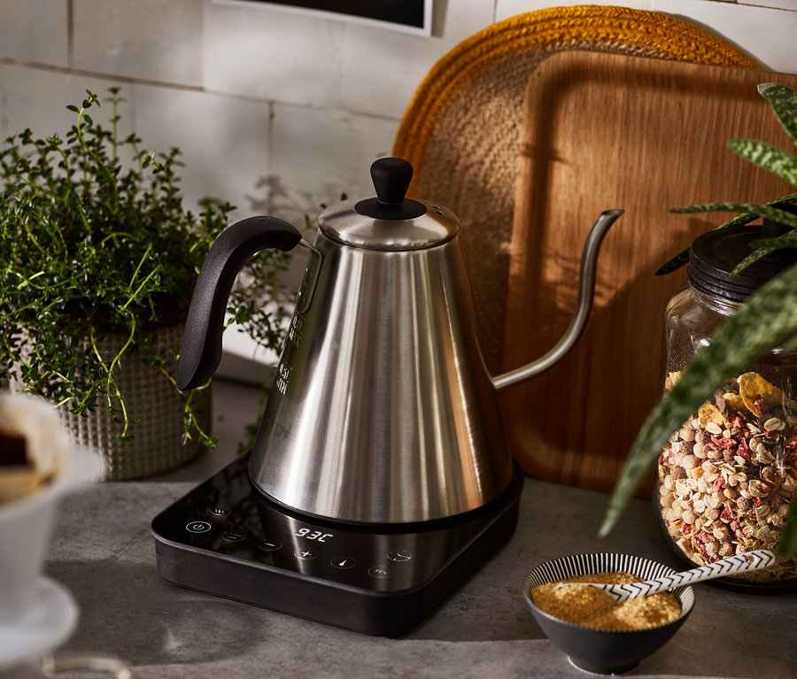 Ein elektrischer Schwanenhalskessel steht auf einer Basis.