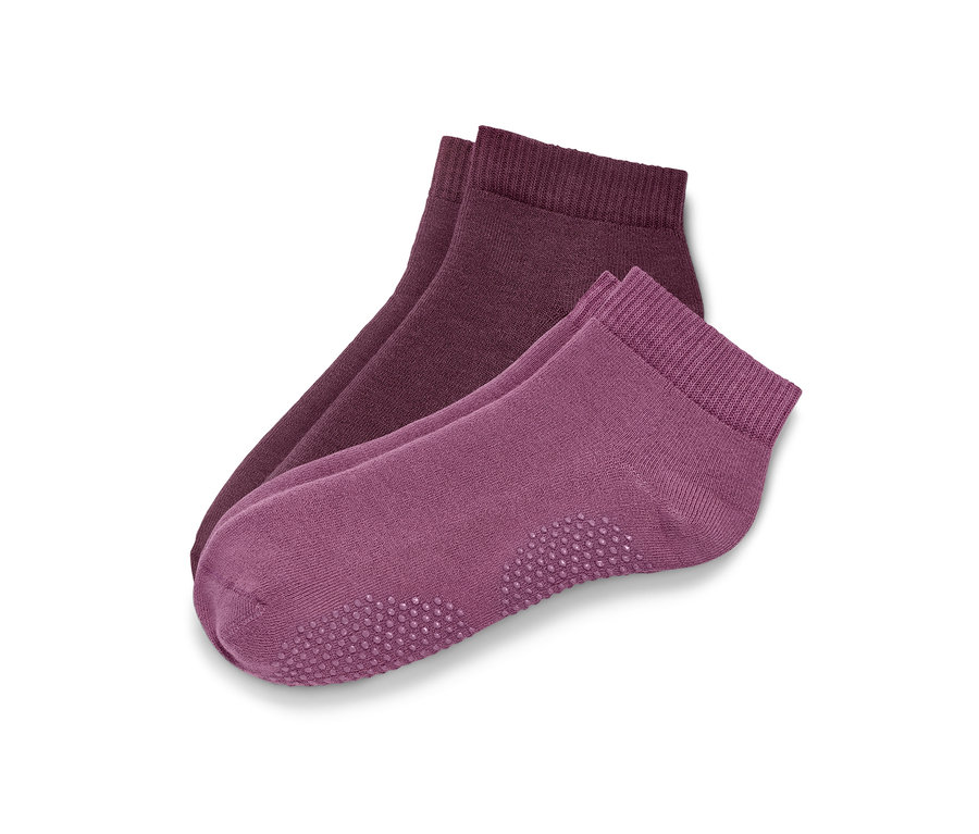 Zwei Paar Yogasocken in Rosé und Mauve.