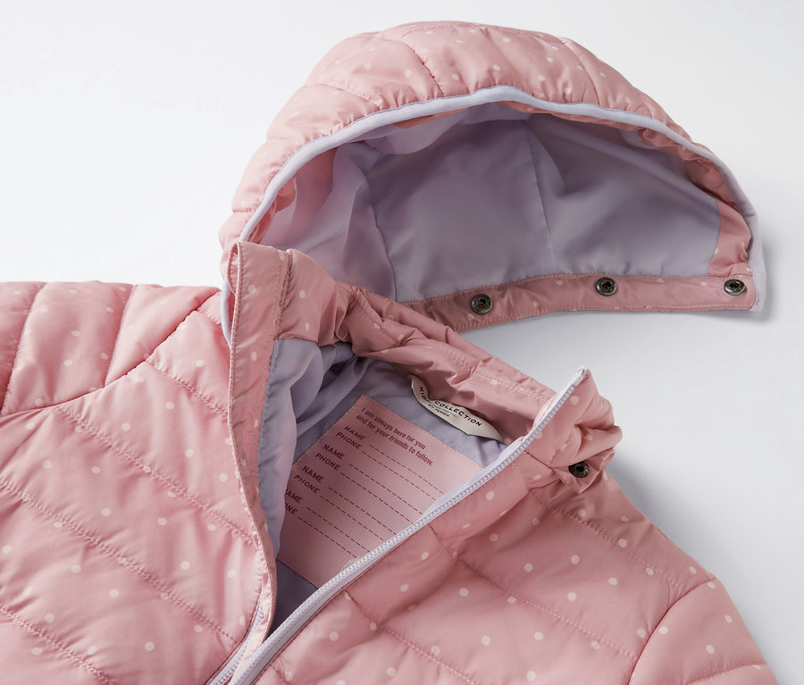 Altrosa Kinder-Steppjacke mit weißen Punkten.