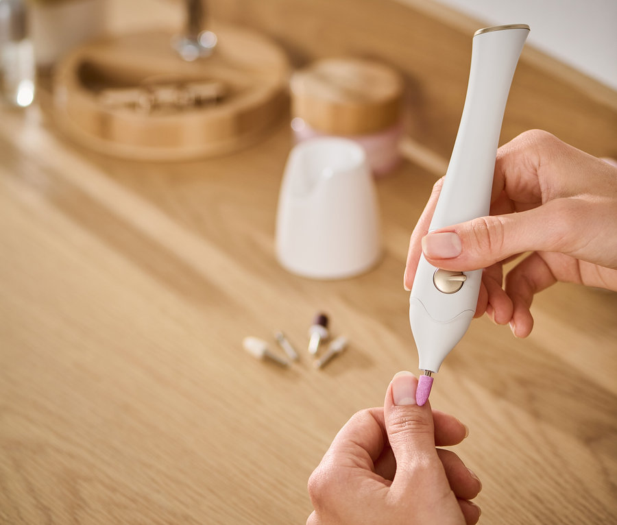 Frau benutzt ein 5-in-1-Maniküre-Pediküre-Set für ihre Nägel.