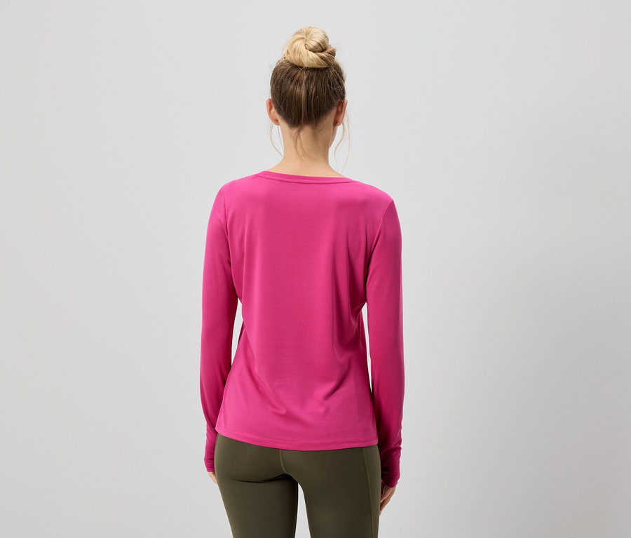 Rückenansicht einer Frau mit Duttfrisur, die ein pinkfarbenes Langarmshirt und olivgrüne Leggings trägt.
