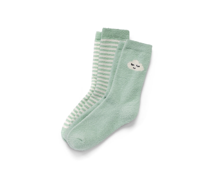 Zwei Paar Kuschelsocken: ein Paar hellgrün mit Wolkenmotiv, ein Paar mit weißen Streifen auf hellgrünem Grund.