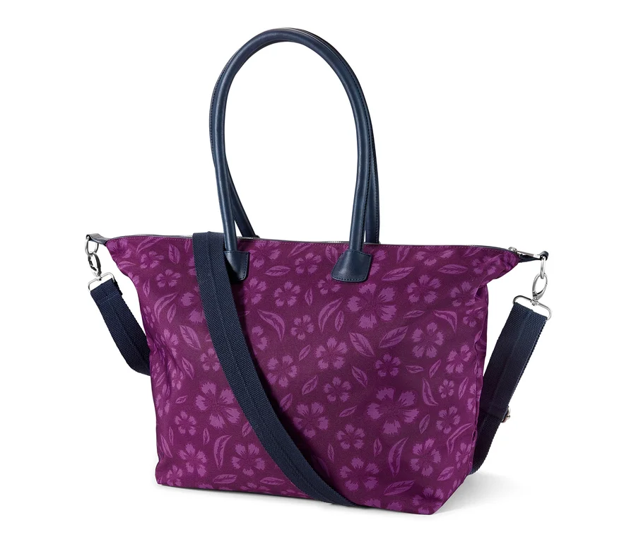 Lila Sicherheits-Shopper mit Blumenmuster und dunkelblauen Henkeln.