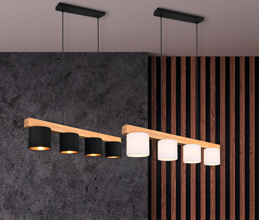 Zwei Trio Pendelleuchten »Cameron« hängen über einem grauen Sofa. Eine ist schwarz, die andere ist weiß.