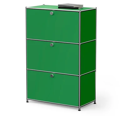 Grüner Schrank mit drei Schubladen und einem Buch darauf.