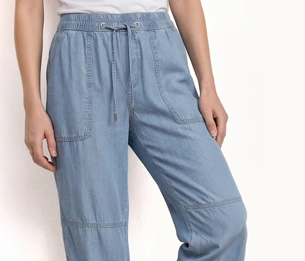 Person trägt Street One Joggpants »Bonny« aus hellblauem Denim mit Kordelzug und Taschen.