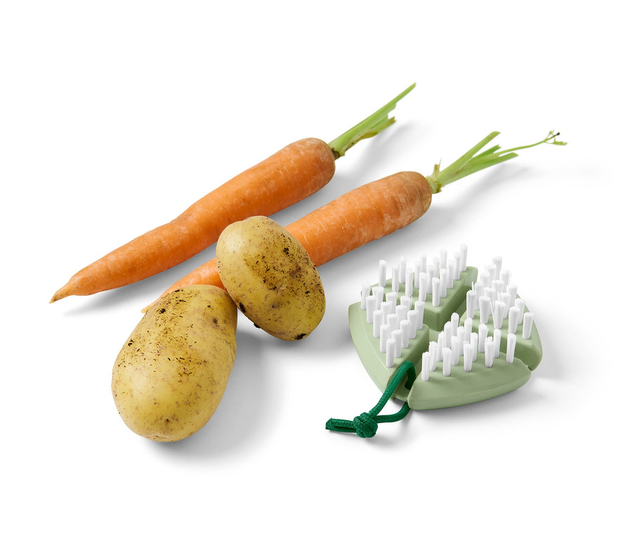 Zwei Karotten und zwei Kartoffeln liegen nebeneinander und neben einer flexiblen Gemüse-und-Obstbürste.