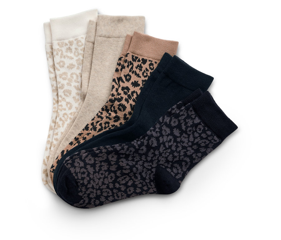 Fünf Socken liegen übereinander, darunter Socken mit Leopardenmuster und einfarbige Socken.