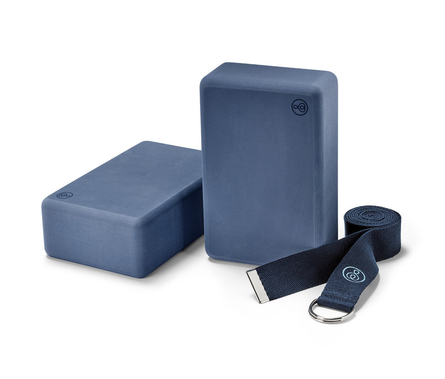 Zwei Yogablöcke und ein zusammengerollter Yogagurt aus dem Yoga-Set.