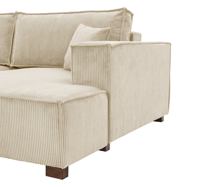 Detailansicht eines cremefarbenen Cord-Sofas mit Armlehne und losen Kissen.