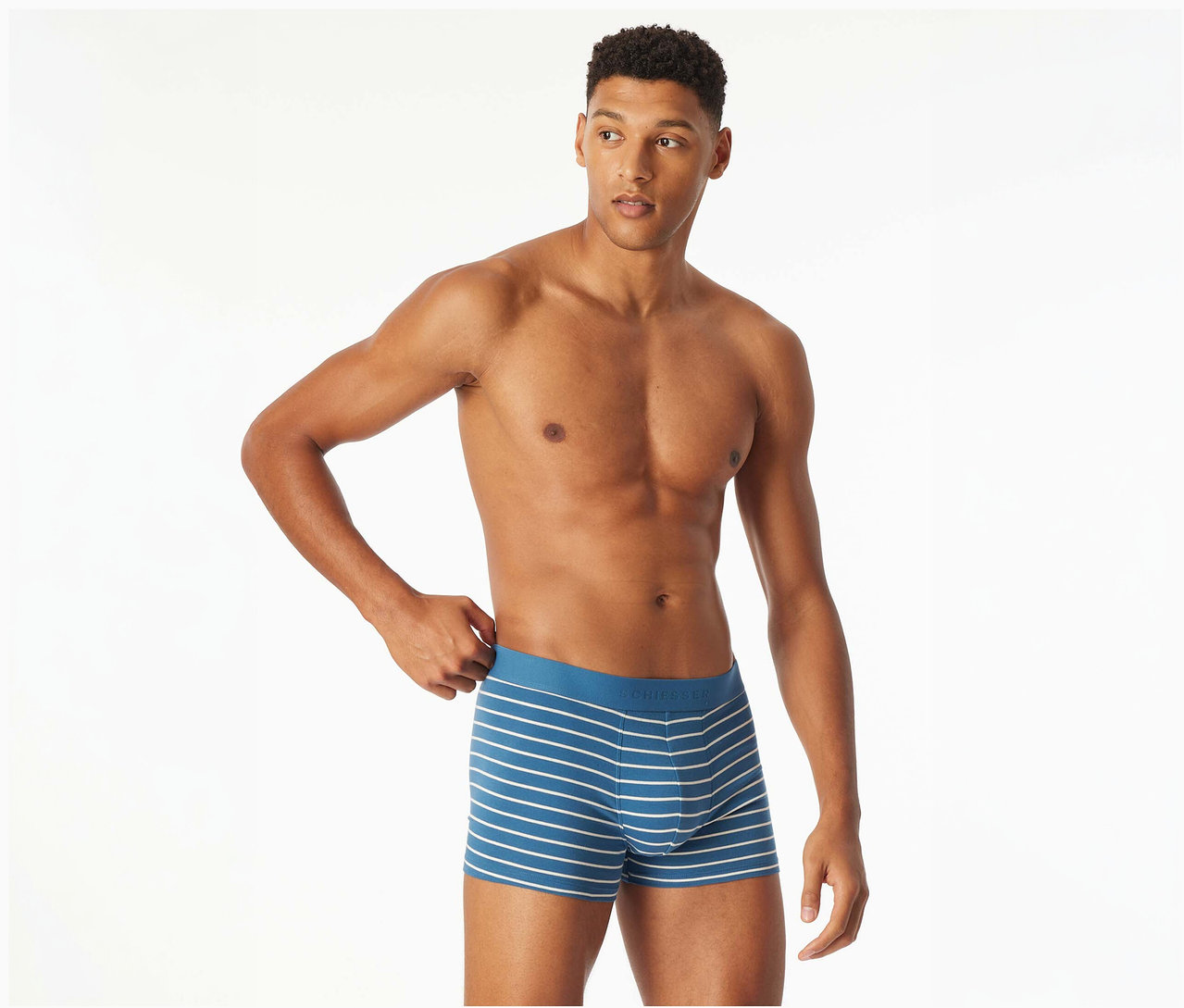 Mann zieht leicht am Bund einer blau-weiß gestreiften SCHIESSER Slipboxer.
