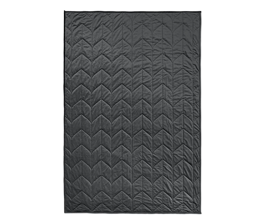 Eine graue Entspannungs-Gewichtsdecke mit geometrischem Steppmuster.